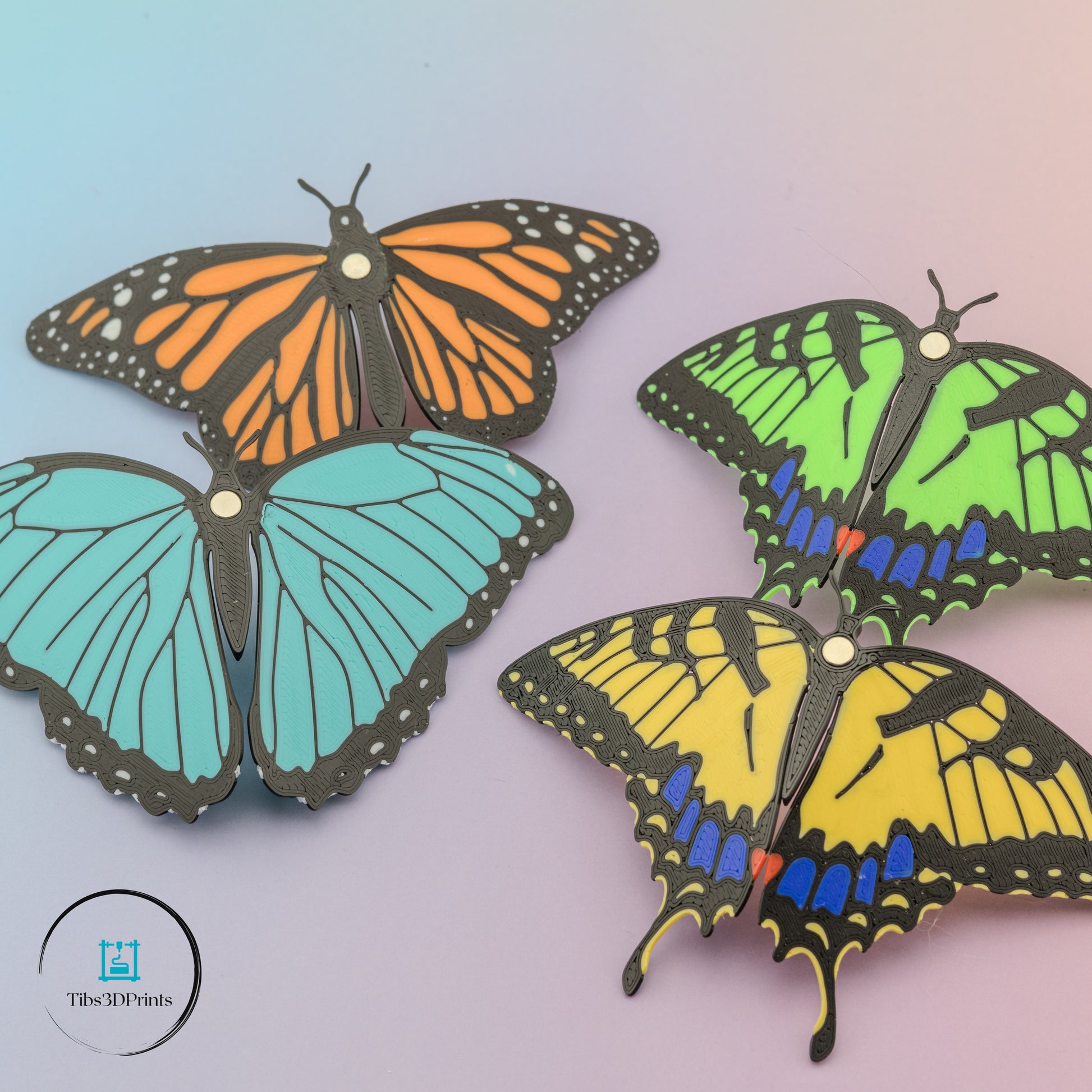 Four butterfly magnets displayed on white surface